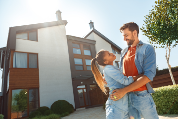 couple in front of a house